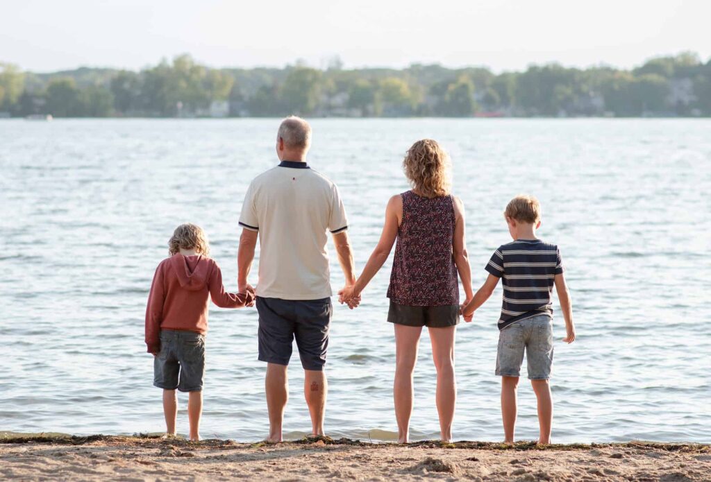 Family holding hands at the beach