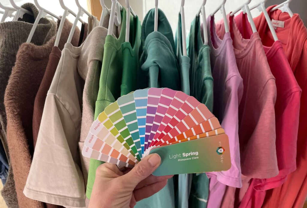 Light spring season color fan in front of a rack of matching clothes